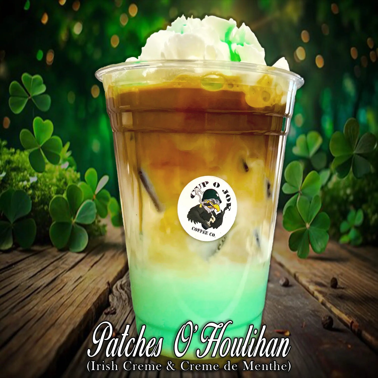 A festive iced espresso drink with a striking green and brown gradient, topped with whipped cream and a touch of green drizzle. The background features vibrant shamrocks, capturing the St. Patrick’s Day spirit. The Cup O Joe logo is displayed on the cup.